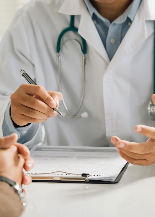 Dr in white coat consulting
